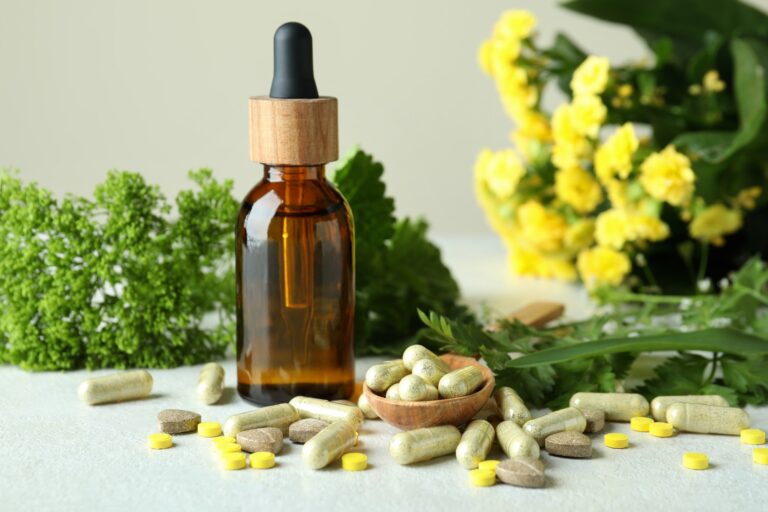 Concept of herbal medicine pills on white textured table, close up