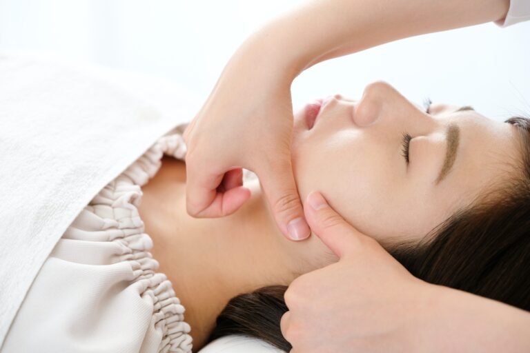 Hands of women and practitioners receiving face massage